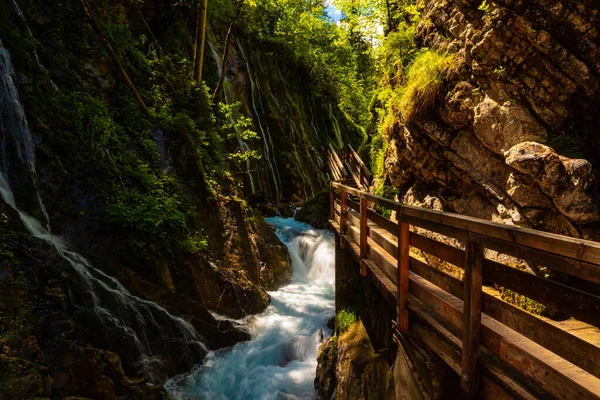 Beautiful wooden path trail for nature trekking and alp hiking with mountain river, canyon and waterfall, located in Wimbachklamm, Berchtesgaden, Bavaria, Germany (Bavarian Alps)