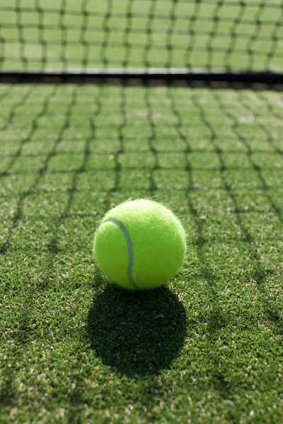 Tennis balls on tennis grass court — Stock Photo, Image