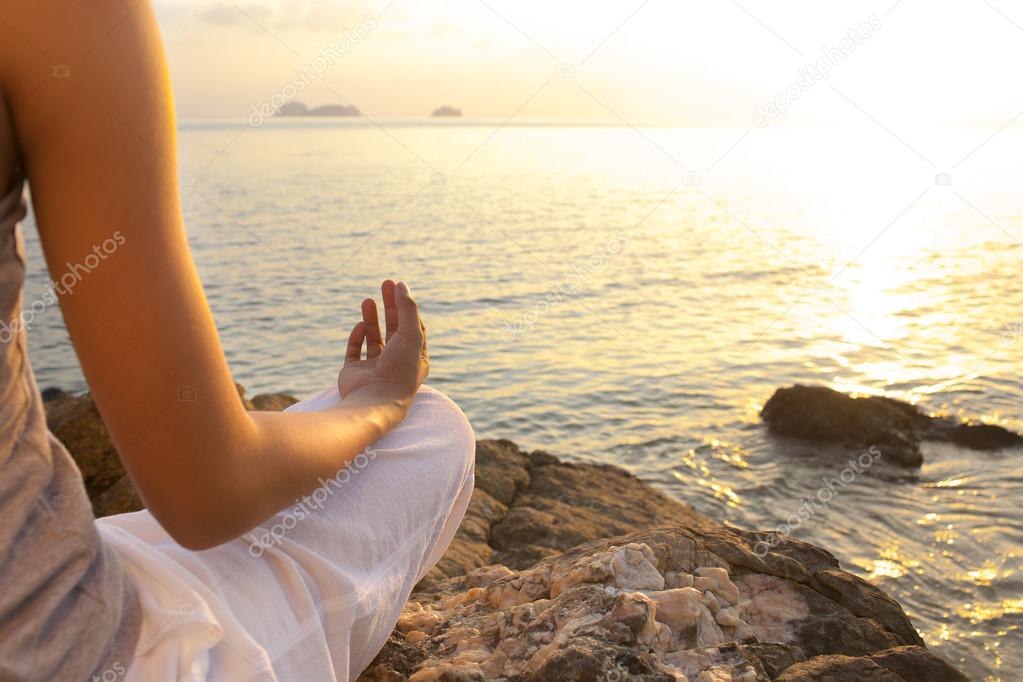 Young woman meditation yoga pose on the beach