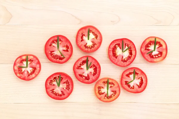 Fresh tomato cut half with rosemary leaf as a clock. World clock — Stock Photo, Image