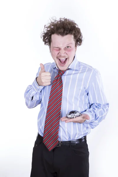 Businessman with miniature car on white background — Stock Photo, Image