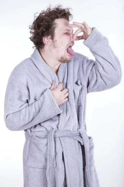 Funny man with bathrobe on white background Stock Picture