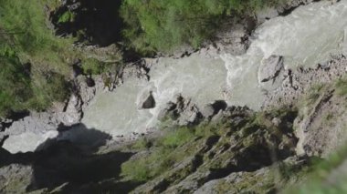 A mountain river with clear blue water