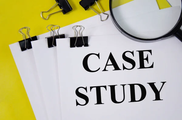 Case study concept word written on white paper and yellow background with magnifier