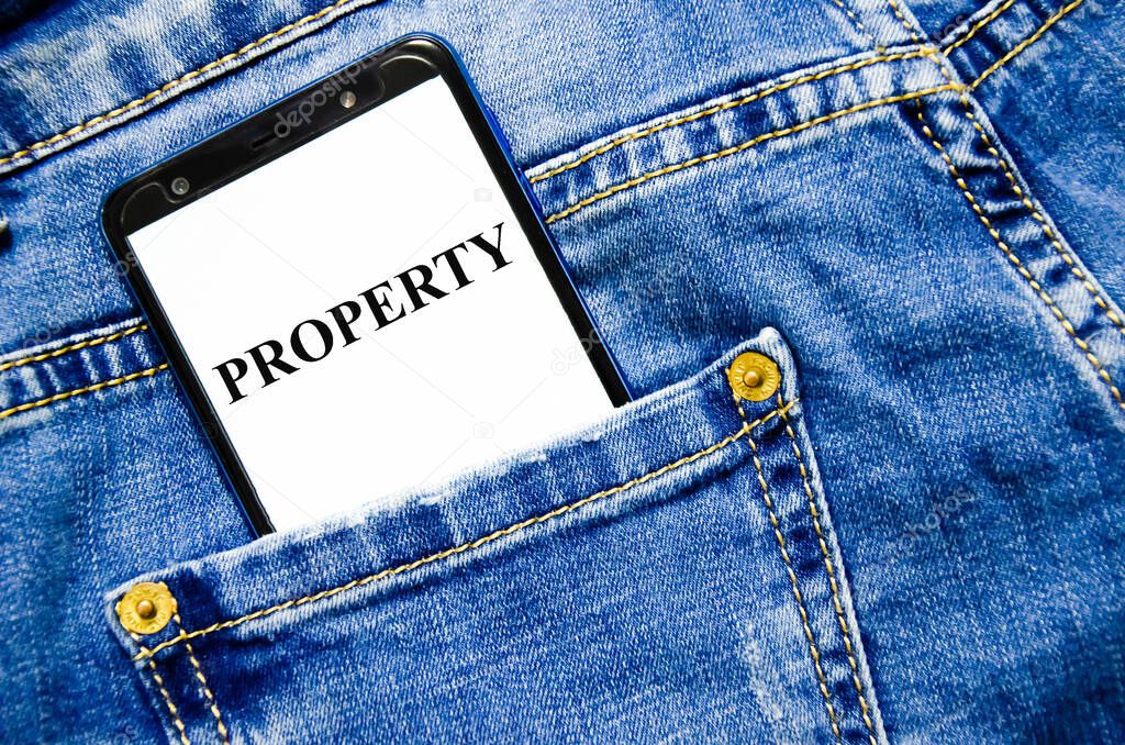 property the text is written on the white screen of the phone shortly lies in jeans. word