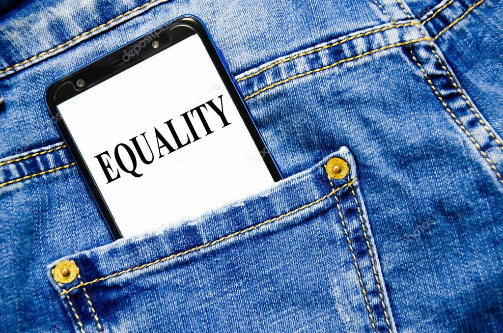 equality the text is written on the white screen of the phone shortly lies in jeans