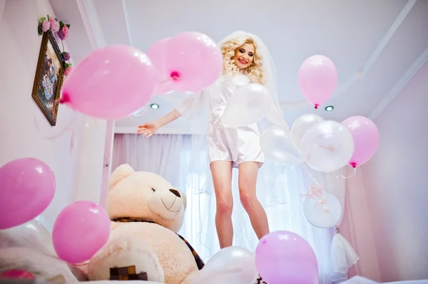 Young sexy blonde bride having fun at her pink room — Stock Photo, Image