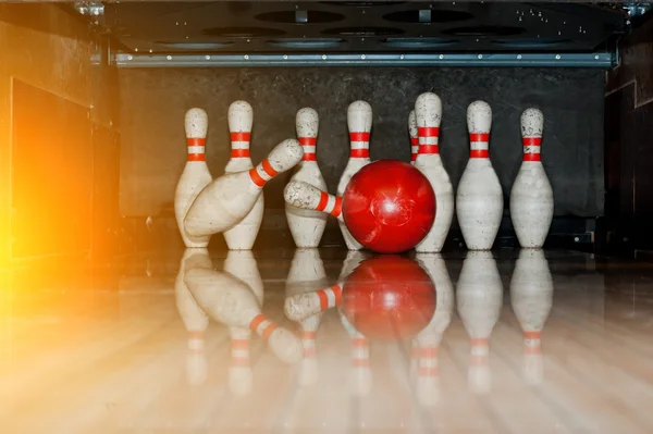 Dieci spilli bianchi in una pista da bowling con palla colpita — Foto Stock