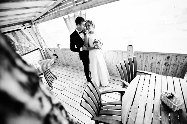 Wedding couple hugging at wooden  cafe — Stock Photo, Image