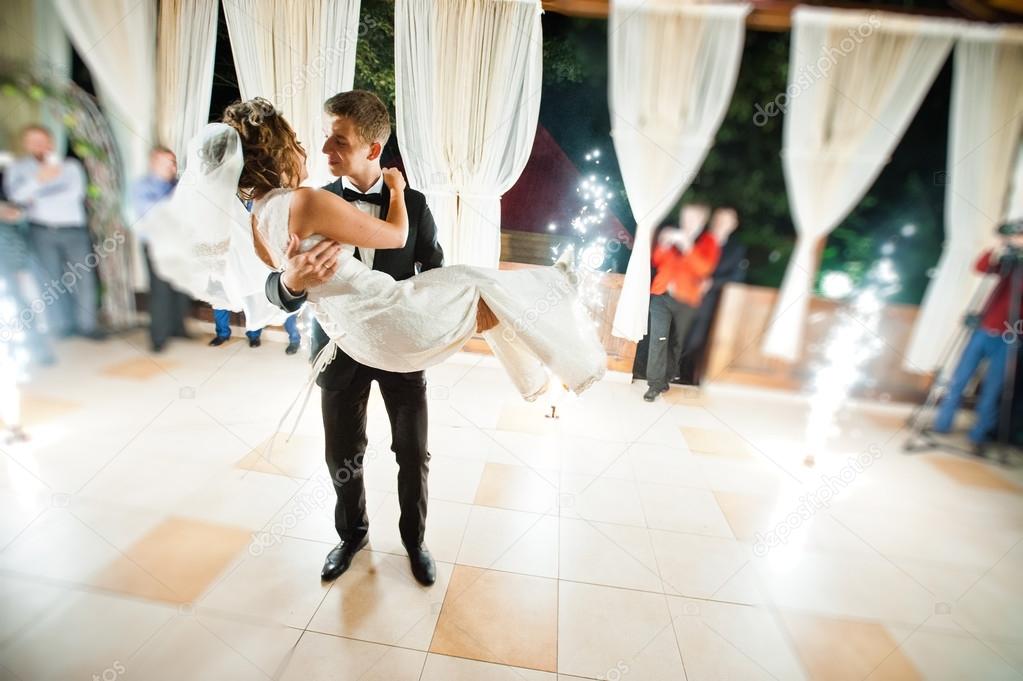 First wedding dance with fireworks of wedding couple. Photo with