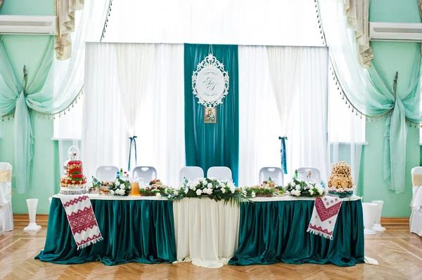 Table of newlyweds in white and green velvet colors — Stock Photo, Image