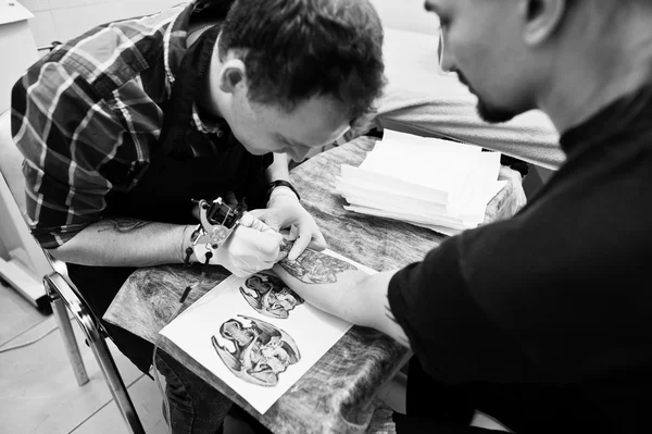 Tatuagem mestre fazer tatuagem para homem de balancim no salão de tatuagem — Fotografia de Stock