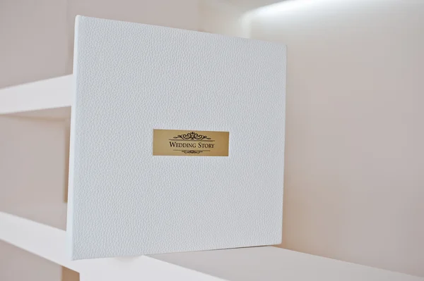 White leather wedding album with golden metallic insert text Wed — Stock Photo, Image