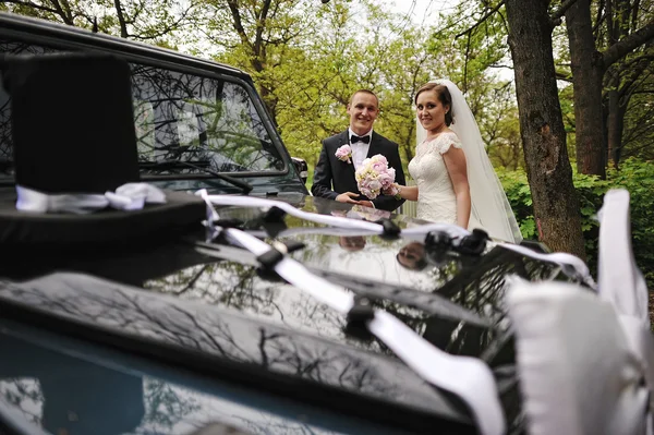 Graceful wedding couple background black wedding car