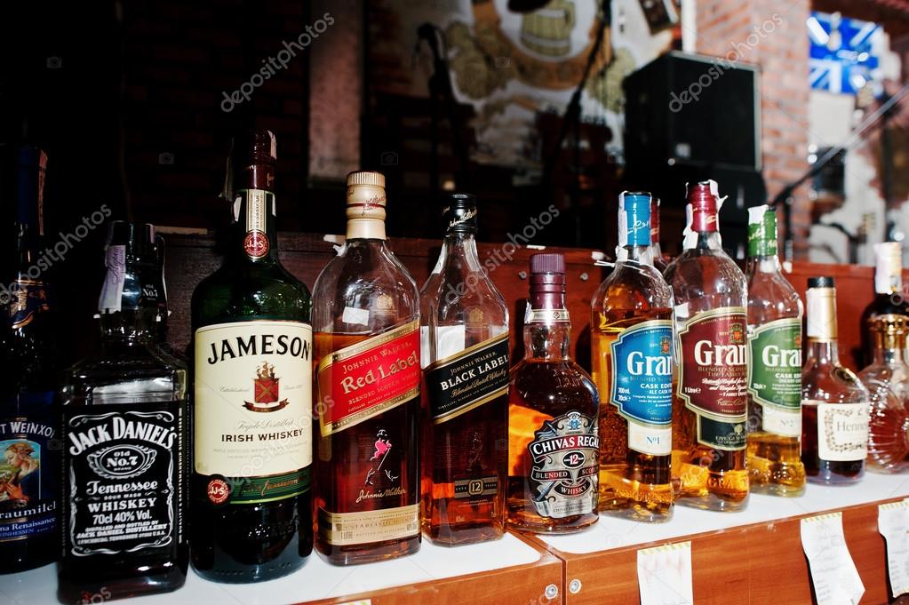 KYIV, UKRAINE - MARCH 25, 2016: Various alcoholic beverages bottles in the bar.