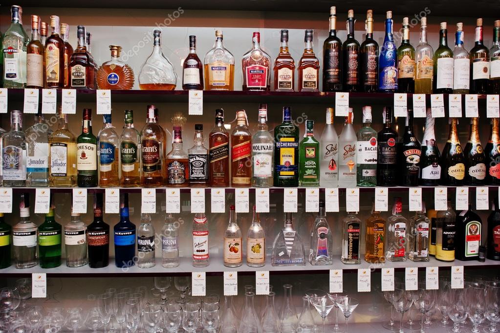 KYIV, UKRAINE - MARCH 25, 2016: Various alcoholic beverages bottles in the bar on the shelf.