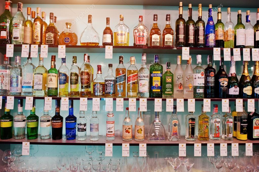 KYIV, UKRAINE - MARCH 25, 2016: Various alcoholic beverages bottles in the bar on the shelf.
