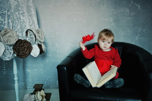 Piccola principessa carina ragazza seduta su una sedia, leggere il vecchio libro e — Foto Stock