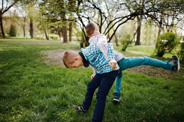 Two brother boy with headphones having fun on park. Brother love — Stock Photo, Image