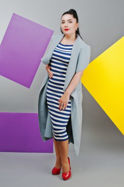 Young woman portrait with blank yellow and purple banner, board 