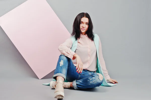 Full length studio portrait of young girl model at ripped jeans