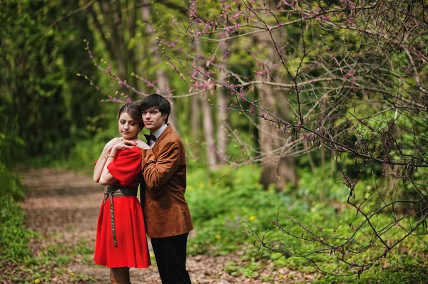 Couple hugging at forest with spring branches. Stylish man at ve — Stock Photo, Image
