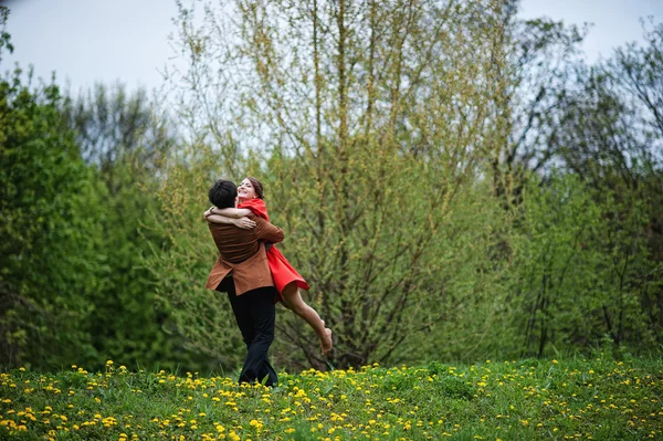 Pareja abrazándose en amor fondo amarillo flores campo. Elegante —  Fotos de Stock