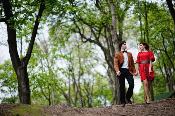 Casal feliz andando apaixonado no parque verde. Homem elegante em velve — Fotografia de Stock