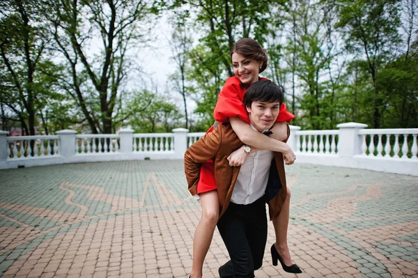 Happy couple walking in love. Stylish man at velvet jacket rolls — Stock Photo, Image