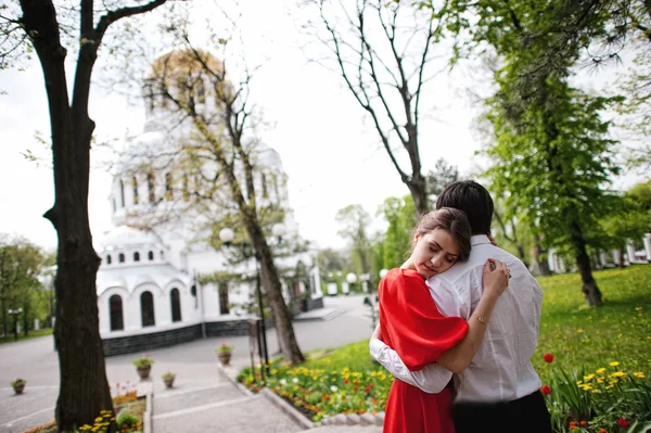 Couple hugging in love background church. Stylish man at velvet — Stock Photo, Image