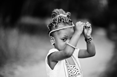 African baby girl walking at park clipart