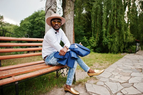 Rico homem negro sentado no banco em óculos de sol, chapéu e dourado sh — Fotografia de Stock