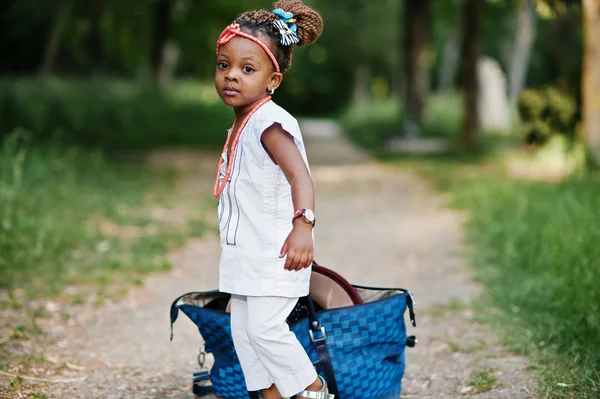 Funny african baby girl with big bag at park — Stock Photo, Image