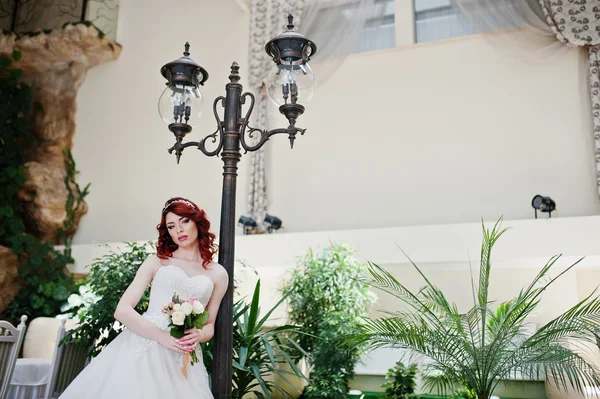 Portrait of charming red-haired bride model with wedding bouquet — Stock Photo, Image