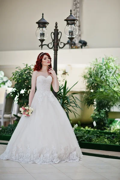 Portrait of charming red-haired bride model with wedding bouquet — Stock Photo, Image