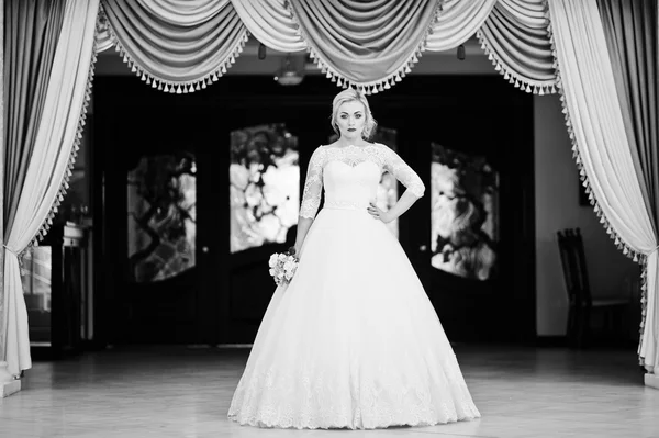 Prachtige blonde bruid gesteld binnen geweldige bruiloft zaal achtergrond — Stockfoto