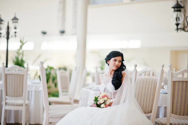 Temptation model brunette bride at exciting wedding dress sittin — Stock Photo, Image