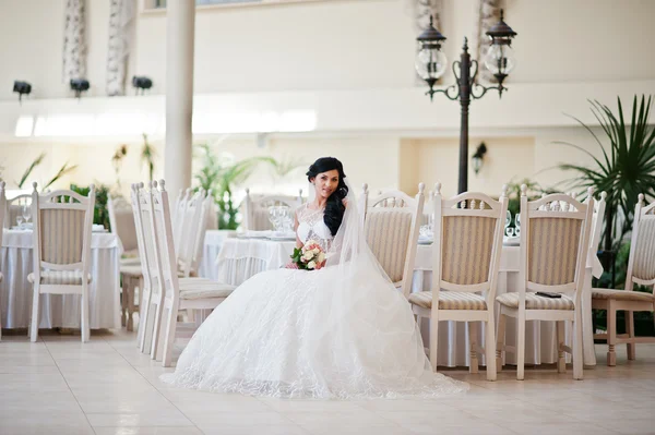 Temptation model brunette bride at exciting wedding dress sittin — Stock Photo, Image