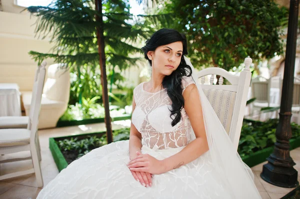 Temptation model brunette bride at exciting wedding dress sittin — Stock Photo, Image