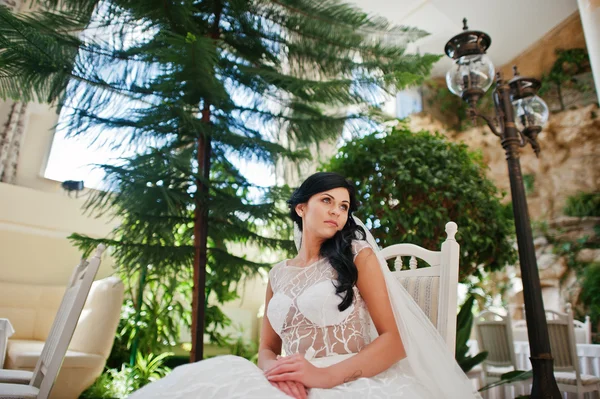 Temptation model brunette bride at exciting wedding dress sittin — Stock Photo, Image