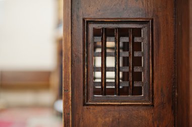 Wooden window of confessional box at church clipart