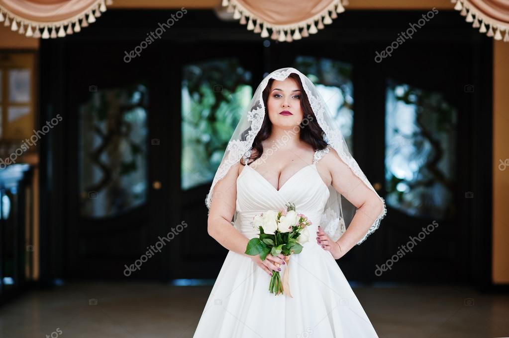 Big Breasts Brunette Bride With Wedding Bouquet Posed At Wedding