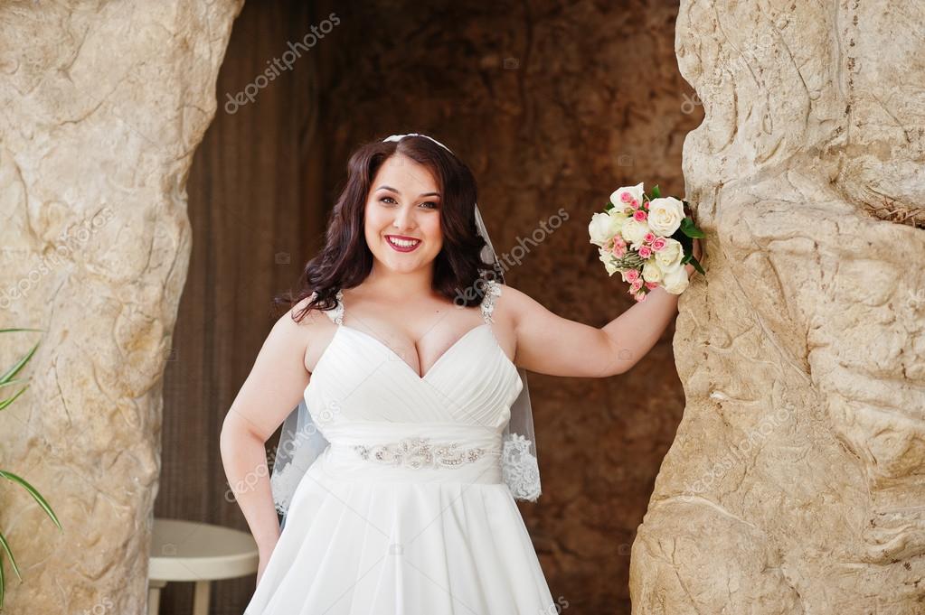 Big Breasts Brunette Bride With Wedding Bouquet Posed At Wedding