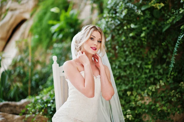 Gorgeous blonde bride sitting on chair and posed at great awesom — Stock Photo, Image