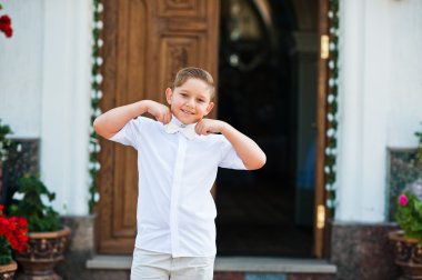 Portrait of little boy on white wear and bow tie on first holy c clipart