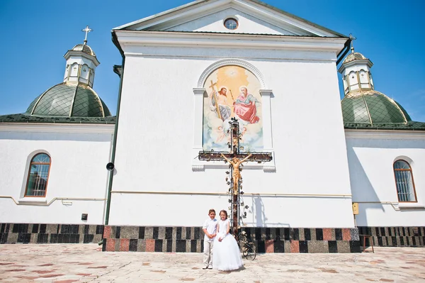 Brother and sister at first holy communion background church cro — Stock Photo, Image