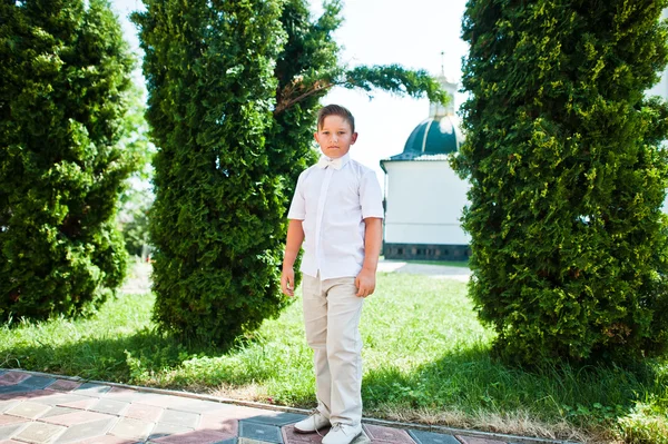 Porträt eines kleinen Jungen auf weißem Kleid und Fliege am ersten heiligen c — Stockfoto