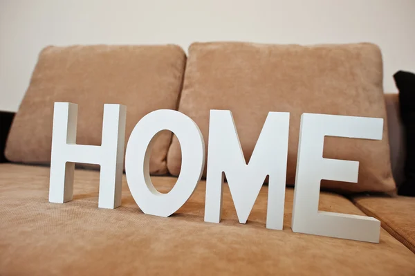 Witte houten letters Home op bed van de Bank van de hoek van de cofee bij lichte room — Stockfoto