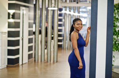 Lokantada poz veren mavi elbiseli Afro-Amerikan kadın..