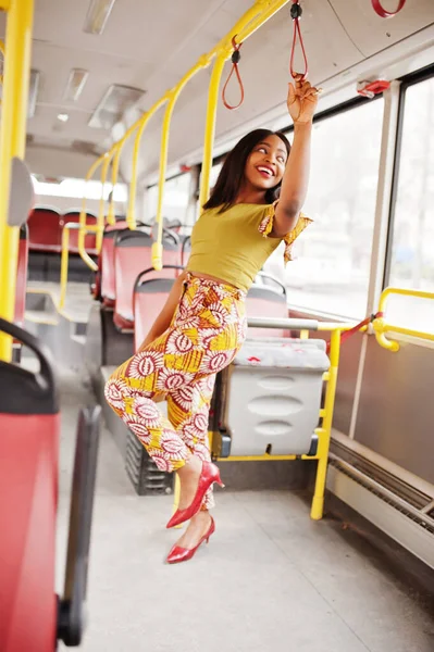 Young stylish african american woman riding on a bus.